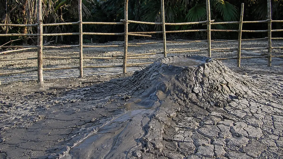 Baratang Island: The Hidden Adventure Most Travellers Miss Baratang Island Mud Volcano with bubbling mud surrounded by tropical forest in the Andaman Islands.